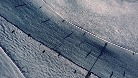 People-skiing-on-white-mountain-slope-with-afternoon-sunlight