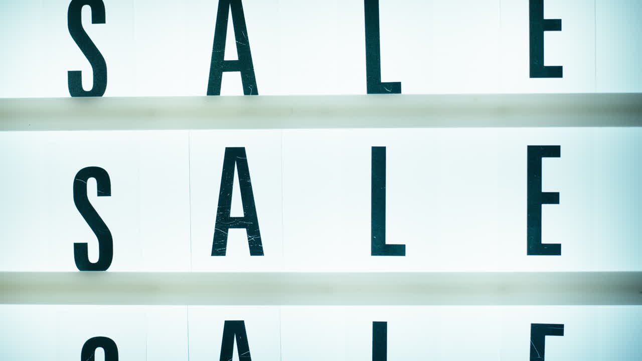 Shopping concept with repeated sale writings on a signboard