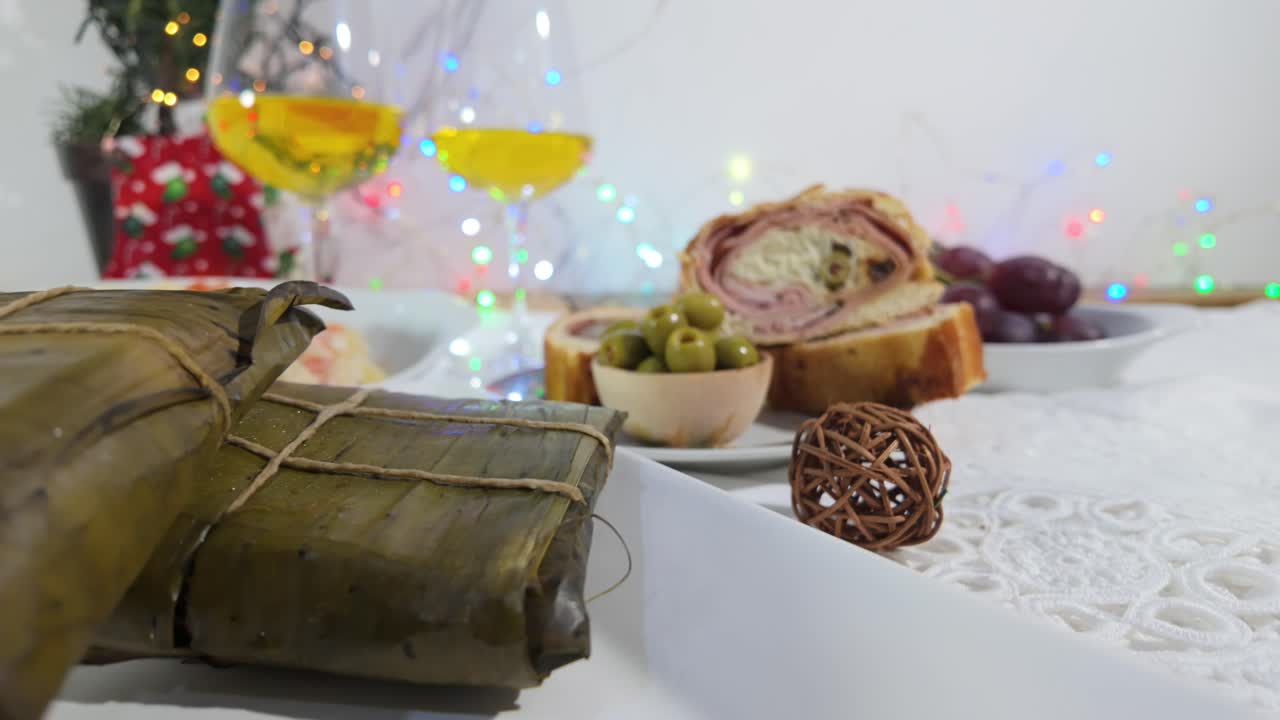 Traditional Venezuelan Christmas foods on festive table with wine and decorations