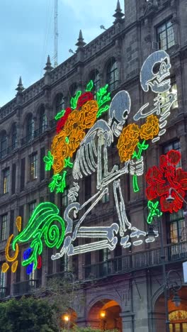 day of the dead light display: a kneeling skeleton with marigolds