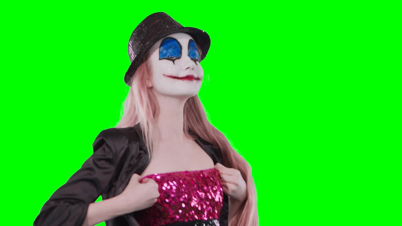 The girl clown fixes the dress kisses laughing at the camera.