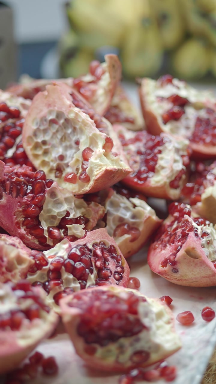 Close-up of Freshly Cut Pomegranate Pieces with Red Seeds
