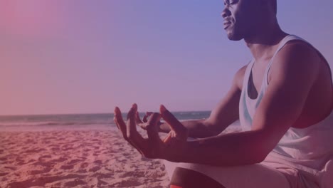Animation of african american man meditating at beach