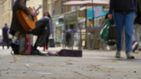 Low-Angle-Shot-of-Busker-On-Busy-Street-In-Oxford-02