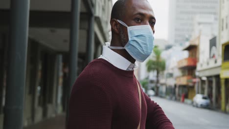 african american man on the go wearing coronavirus covid19 mask