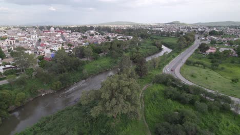 Aerial-shot-revealing-a-bridge-to-cross-the-river