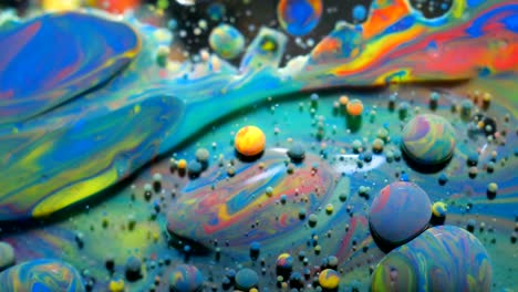 slow motion bright colors bubbles oil beautiful paint universe color moving multicolored closeup. acrylic paint. fantastic surface. abstract colorful paint metamorphosis structure colorful bubbles