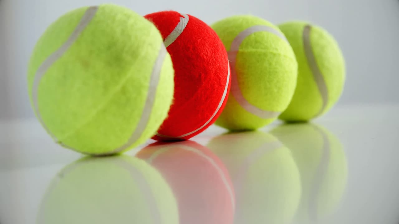 Tennis balls arranged in row 4k