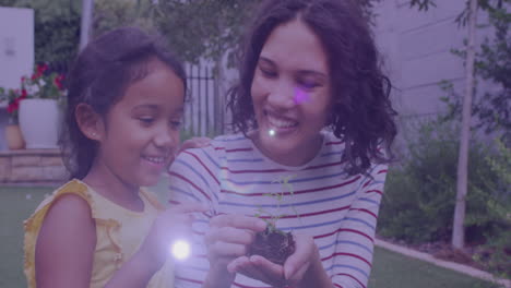 mancha de luz contra madre y hija asiáticas tocando muestras de plantas en el jardín