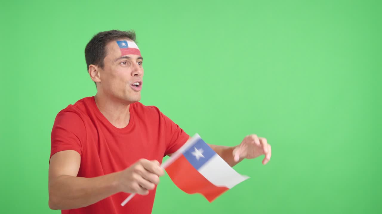 Man cheering for Chile waving a national flag looking away