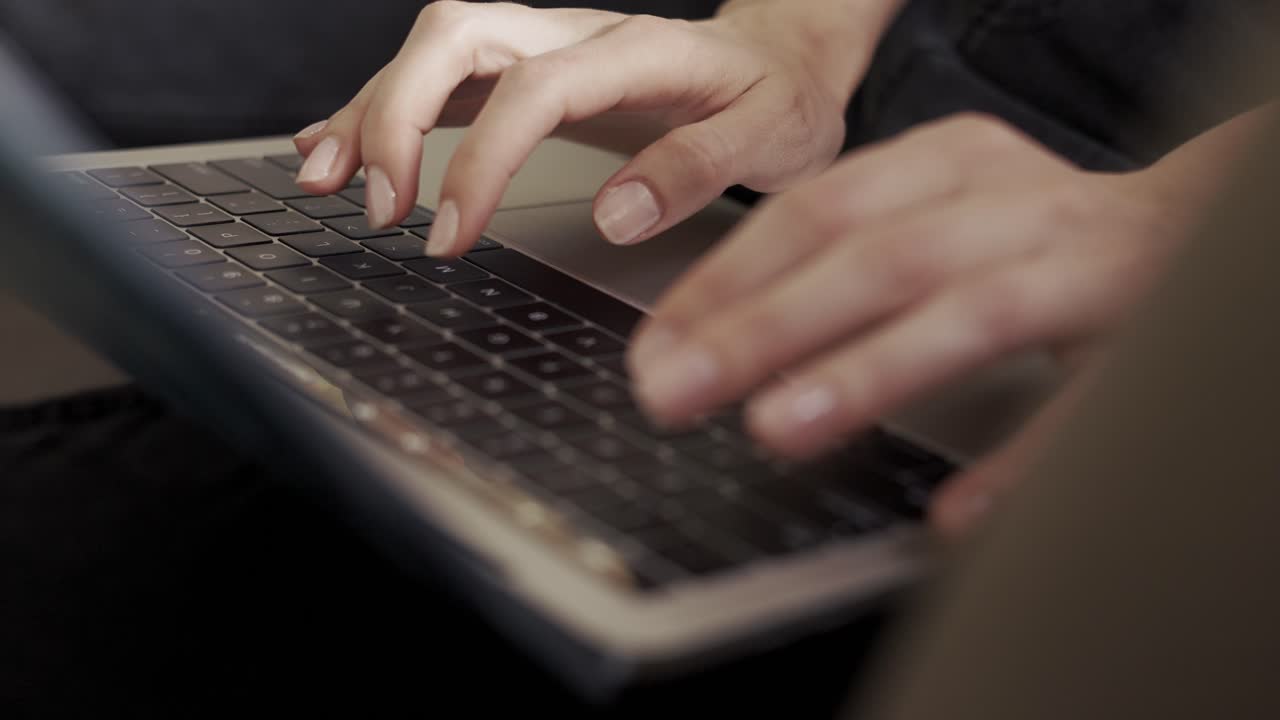Close up of female's hands typing on laptop