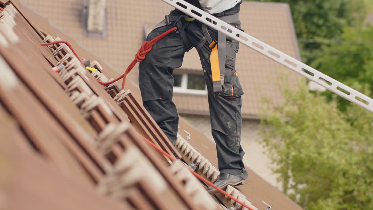 Worker installing railings for solar panels on roof