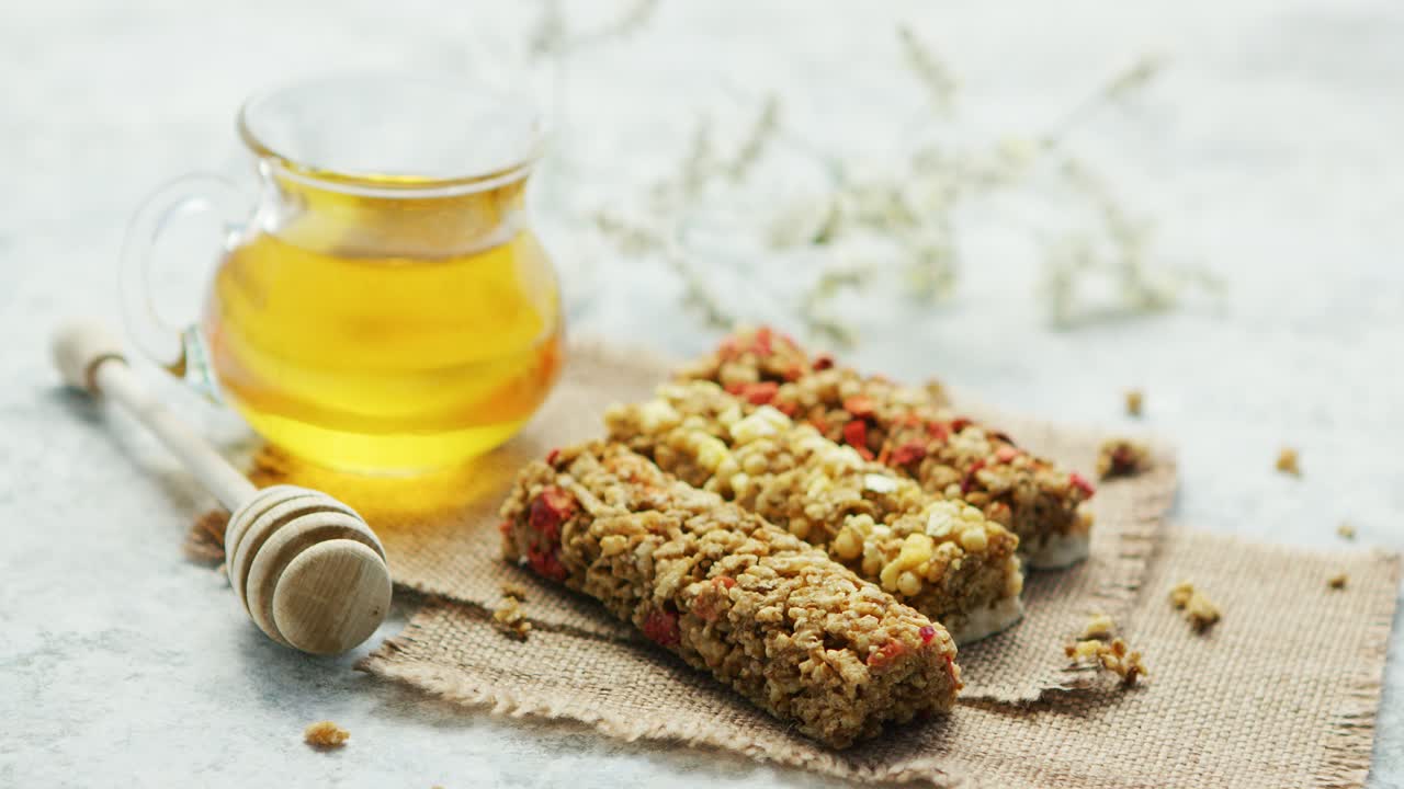 Delicious cereal bars and honey in jar