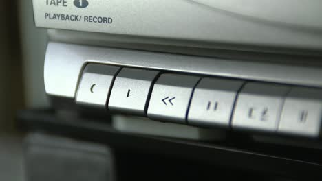 close-up of hitting the play on a boom box tape deck