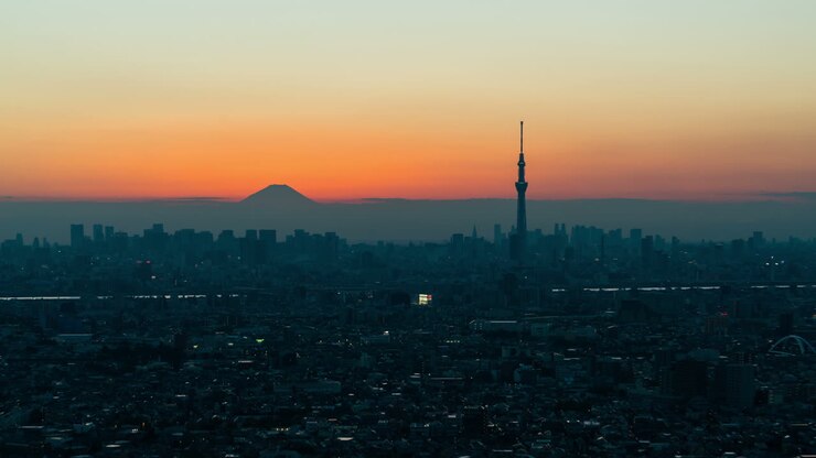 Time lapse Tokyo Skyline and Fuji mountain from day to night sunset