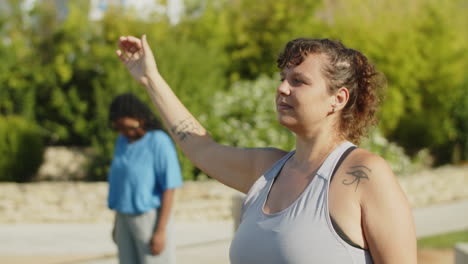 medium shot of cheerful woman stretching neck muscles in park