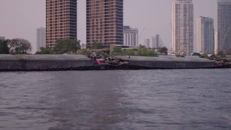 river barges and skyscrapers in bangkok