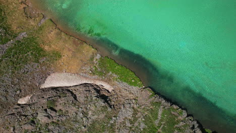 epic looking down cinematic aerial drone high elevation dreamy heavenly island lake silverton ice lake basin unreal caribbean aqua blue silverton colorado snow melt summer rocky mountains up motion