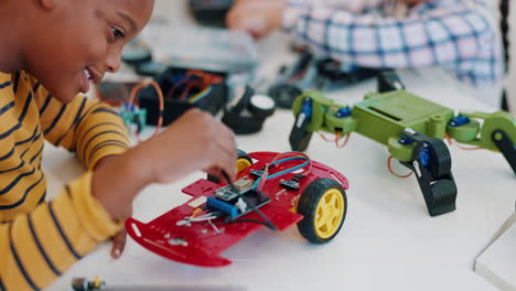 boy, tech and robotics in classroom