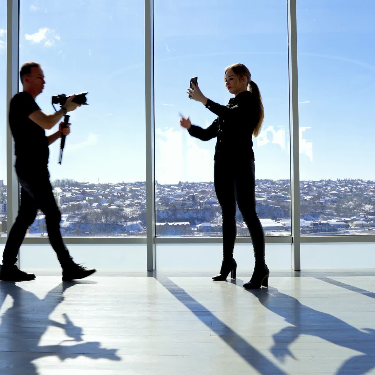 Pretty woman in modern office doing selfie and posing for camera. Businesswoman photoshoot in office