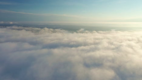 cumulus clouds fill the sky with a dense layer. footage shows a game of light and shadow at sunset. green fields is below.