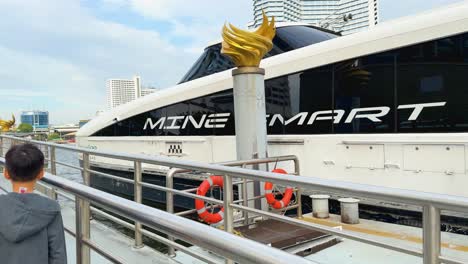 people boarding ferry, scenic river and cityscape