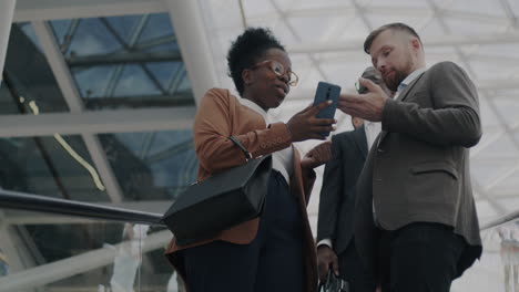 business people discussing on smartphone in modern office