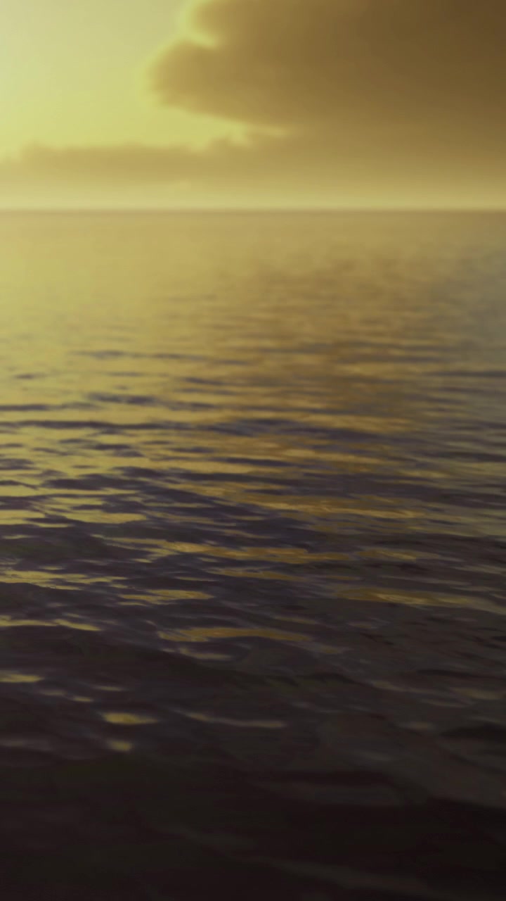 Sunset over calm ocean waters at a distant horizon