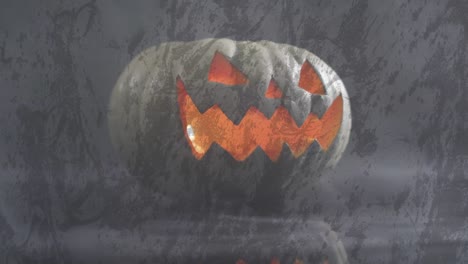 Animation-of-halloween-carved-pumpkin-on-grey-background