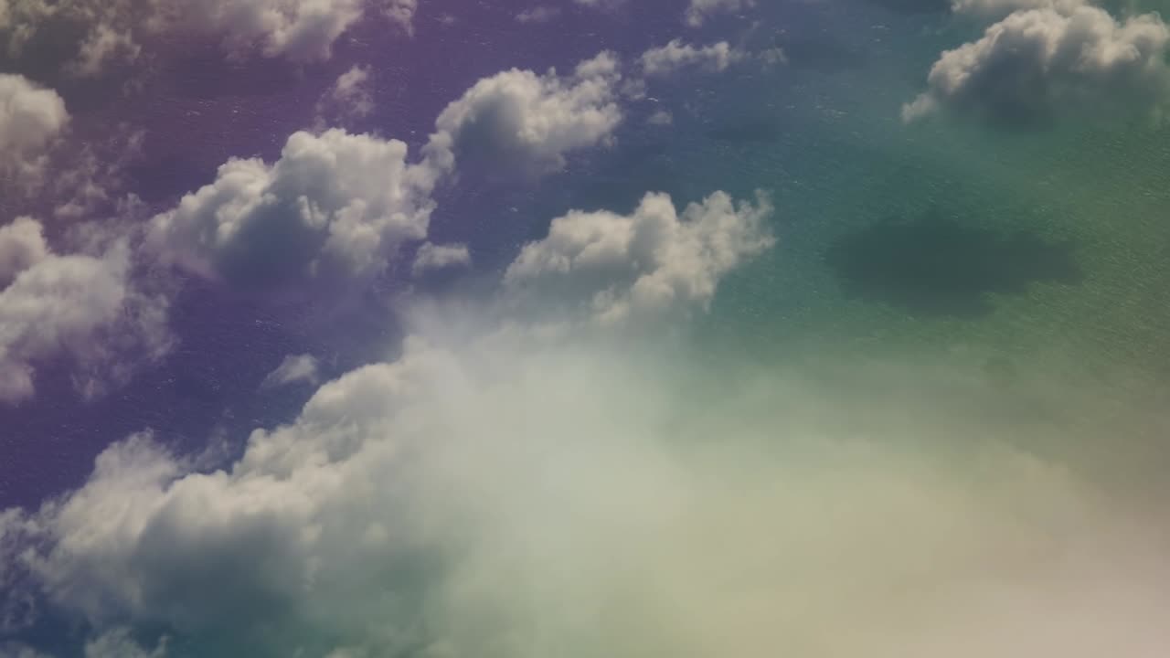 Colorful fantasy water under white clouds view from an airplane above the clouds in the atlantic ocean