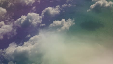 colorful fantasy water under white clouds view from an airplane above the clouds in the atlantic ocean