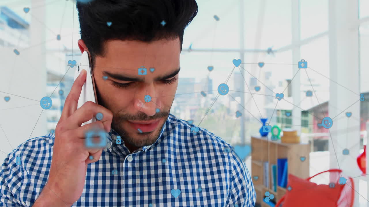 animación de iconos conectados sobre un hombre biracial mirando una tableta digital y hablando en teléfono celular