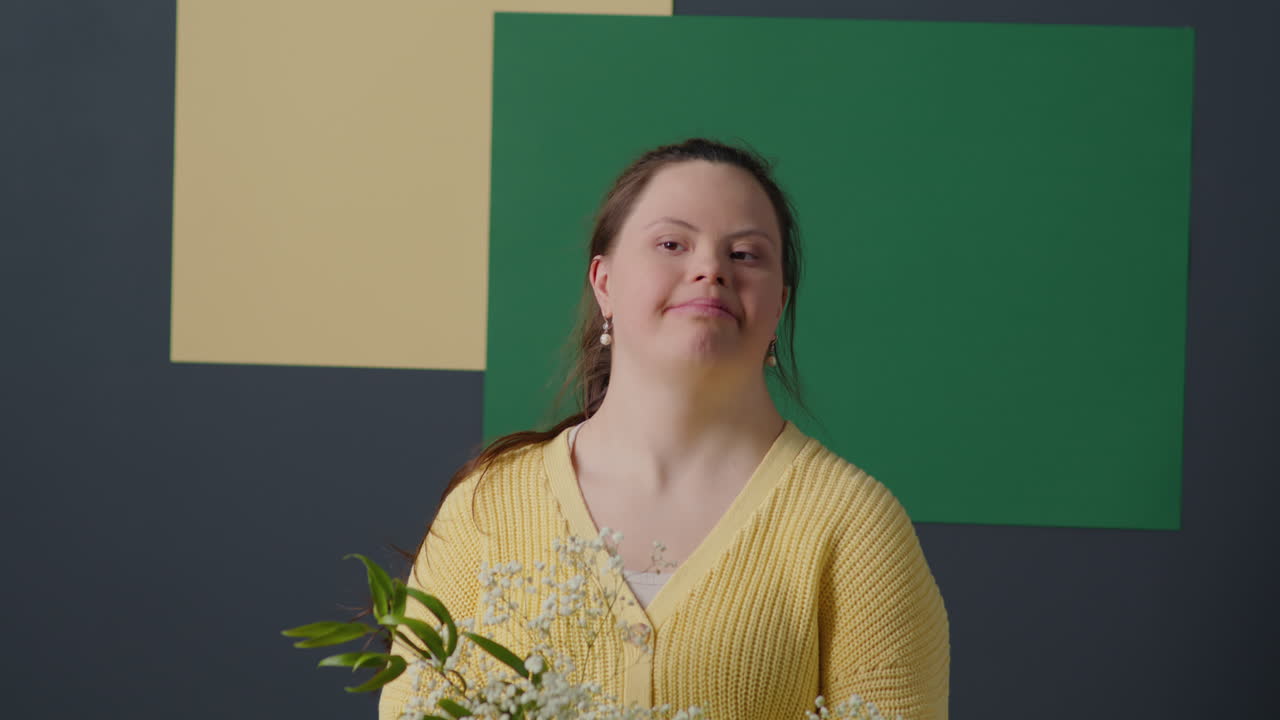 Portrait of Happy Girl with Down Syndrome Holding Flower Bouquet