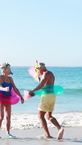 old retired couple dancing near the sea