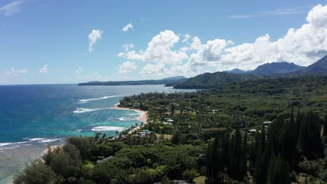 Wide-aerial-shot-flying-over-the-small-Hawaiian-village-of-Haena-on-the-island-of-Kaua'i