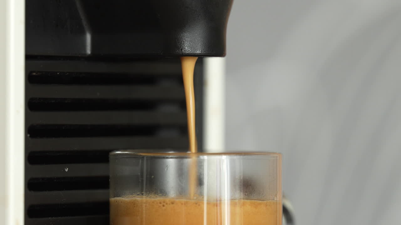 Brewing Espresso From Coffee Maker Machine Filling A Clear Glass