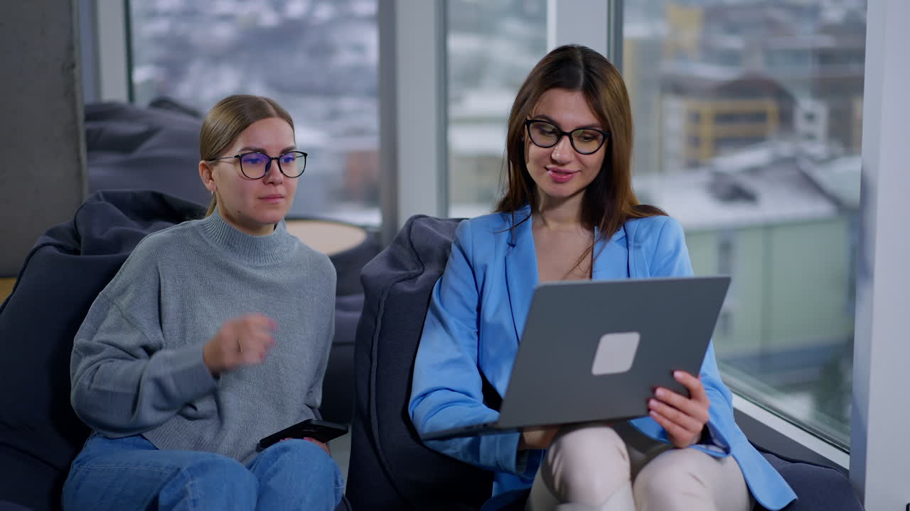 Two women in a meeting looking at laptop