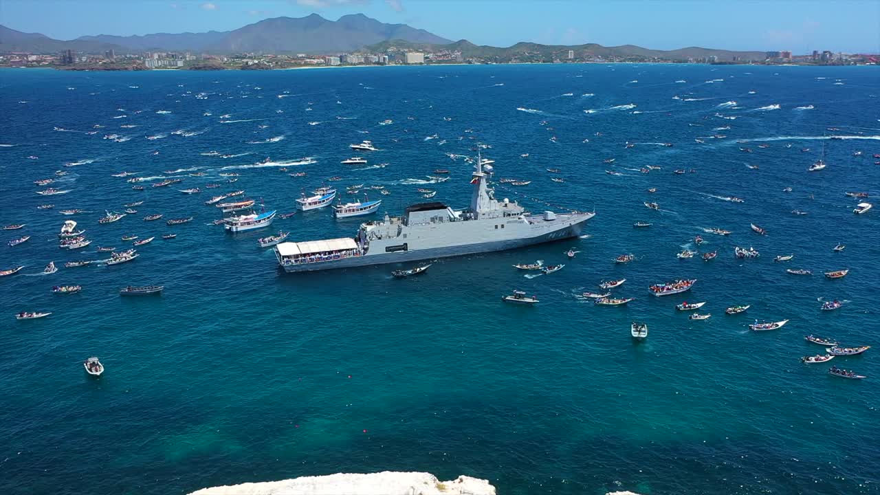 Venezuelan boats in faith procession with military ship and Virgen del Valle