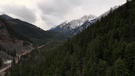 Flying-over-forest-in-mountainous-landscape-near-Duffey-Lake-in-British-Columbia,-Canada