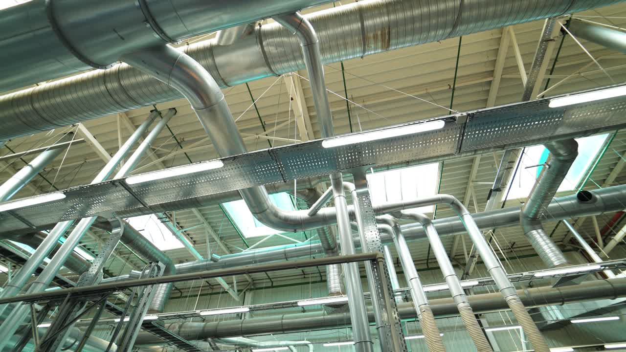 Industrial factory ceiling with ventilation system and lights. Ventilation ducts.