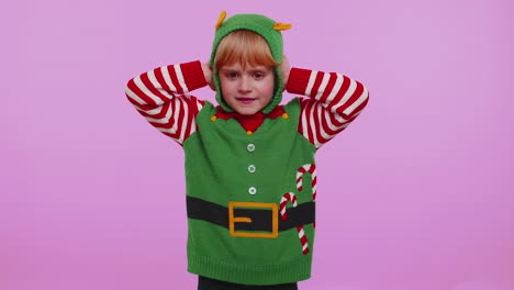 girl kid christmas elf covering ears and gesturing no, avoiding advice ignoring unpleasant noise