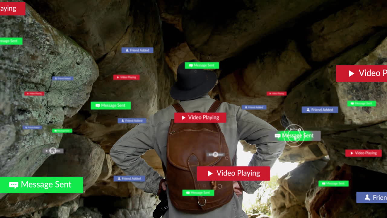 man exploring cave, interacting with floating tech chat bubbles, banners and play buttons
