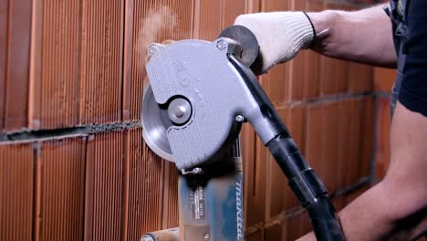 cutting a brick wall with a tile cutter