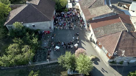 High bird&#039;s eye view of performers dancing and clapping facing crowd, lonoa ethnographic festival