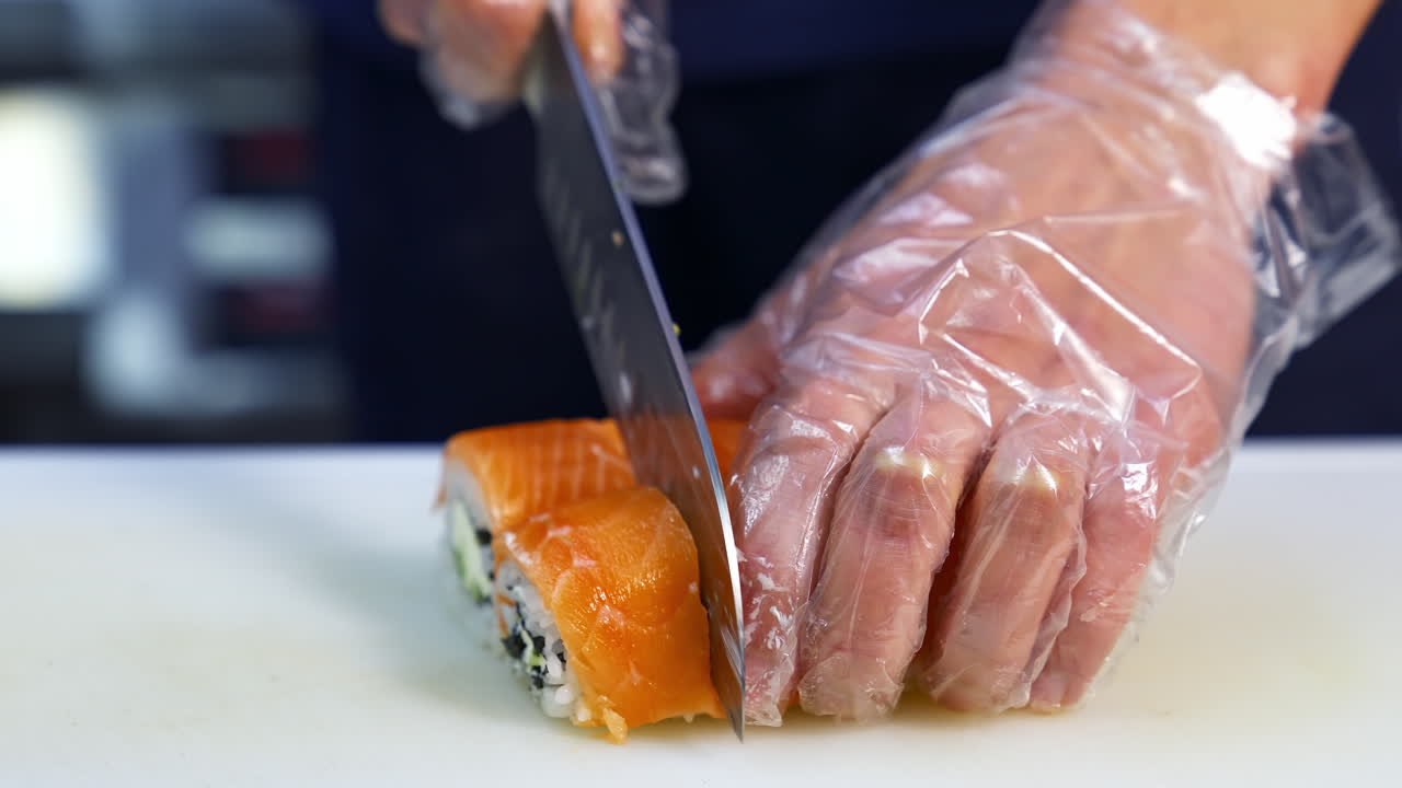 Making Sushi At Restaurant. Chef preparing delicious healthy sushi at restaurant