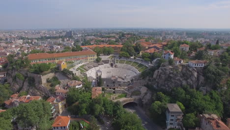 aerial shot approaching an ancient amphitheater in plovdiv, bulgaria