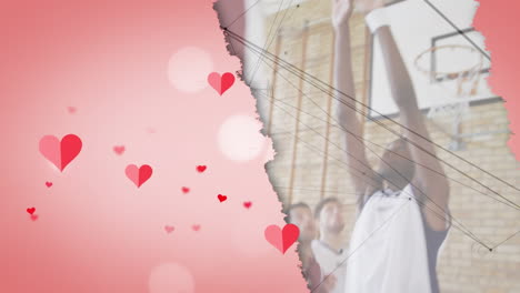 animation of hearts over diverse group of basketball players at gym