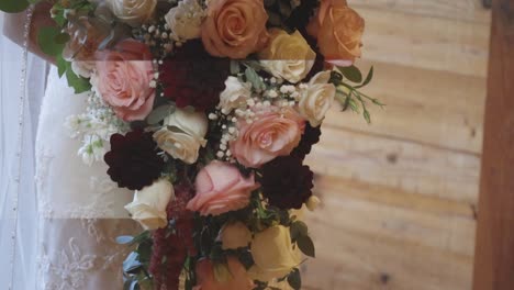 Bride-holds-beautiful-bouquet-close-to-her-waist