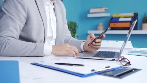 close-up business man hands holding phone and happily approving, giving okay sign.