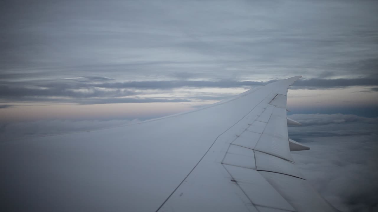 a plane in the sky, view from the plane window to a wing